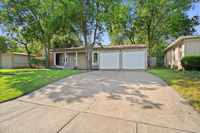 4217 Winfield Ave, Fort Worth, TX 76109 - view of front of house with a front lawn, driveway, a garage, and board and batten siding