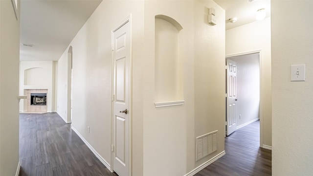 hallway with dark hardwood / wood-style flooring