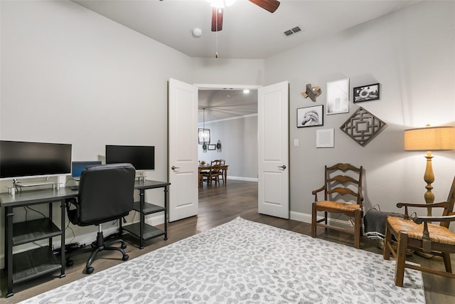 home office featuring dark wood-type flooring and ceiling fan