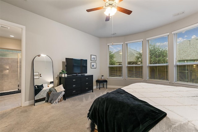 carpeted bedroom featuring ceiling fan and ensuite bath