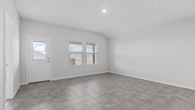 foyer entrance featuring plenty of natural light and vaulted ceiling