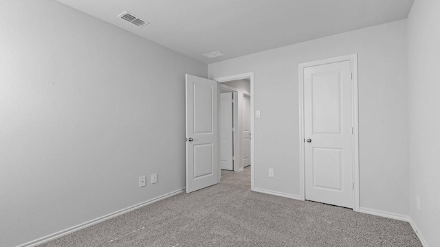 unfurnished bedroom with light colored carpet