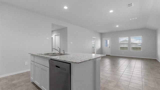 kitchen featuring an island with sink, sink, white cabinets, stainless steel dishwasher, and light stone countertops