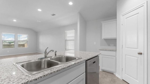 kitchen featuring sink, light stone counters, vaulted ceiling, dishwasher, and white cabinets