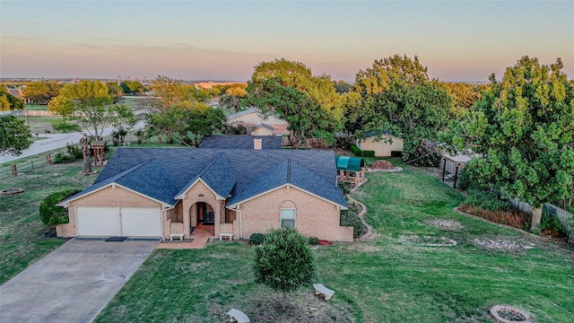 view of front of property featuring a garage and a lawn