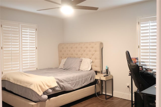 bedroom with ceiling fan and dark hardwood / wood-style floors