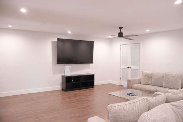 living room featuring wood-type flooring and ceiling fan