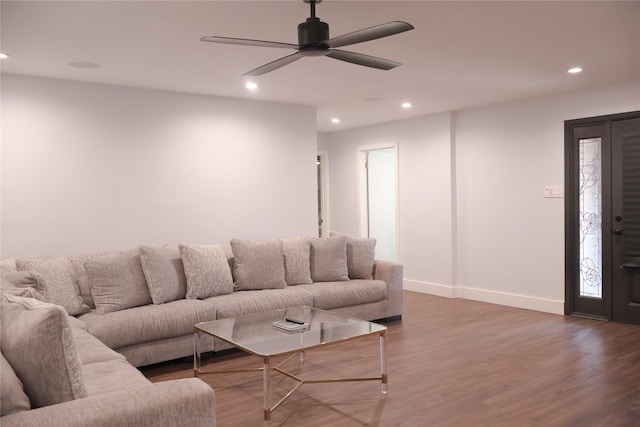 living room with dark wood-type flooring and ceiling fan