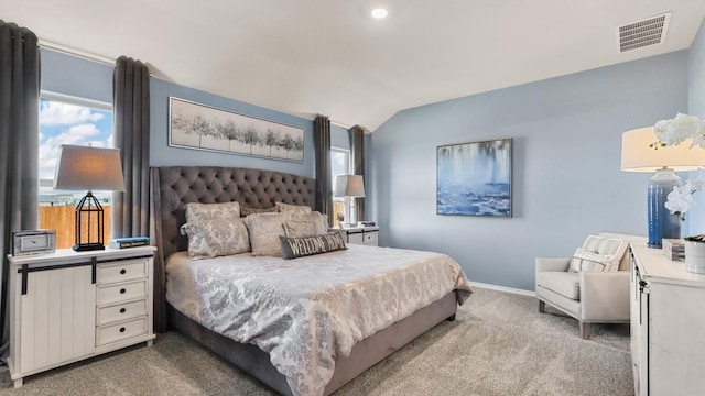 bedroom with vaulted ceiling and light carpet