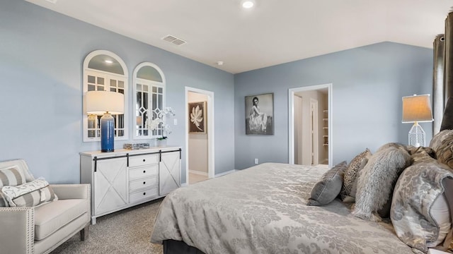 bedroom featuring lofted ceiling and light carpet