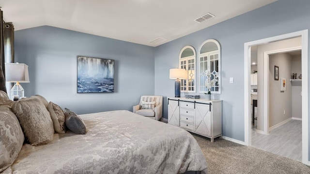 carpeted bedroom with vaulted ceiling