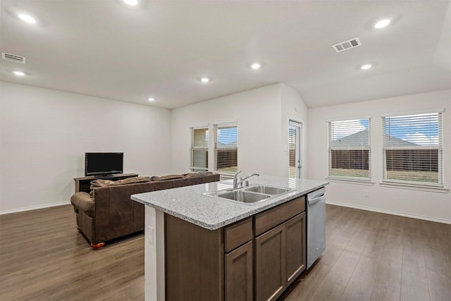 kitchen featuring dishwasher, sink, hardwood / wood-style floors, and an island with sink