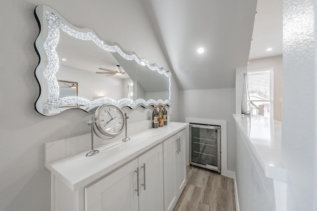 bathroom featuring hardwood / wood-style flooring, vanity, beverage cooler, and ceiling fan