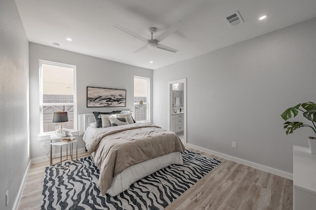 bedroom with ceiling fan, connected bathroom, and light hardwood / wood-style floors