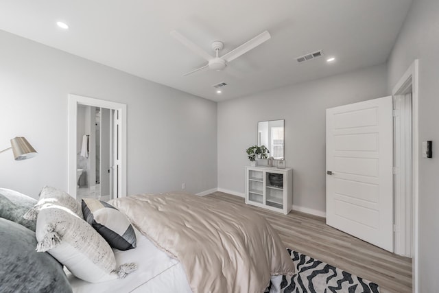 bedroom with hardwood / wood-style flooring, connected bathroom, and ceiling fan