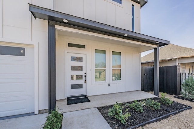 entrance to property featuring a garage and covered porch