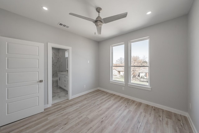 unfurnished bedroom with ceiling fan, connected bathroom, and light hardwood / wood-style flooring