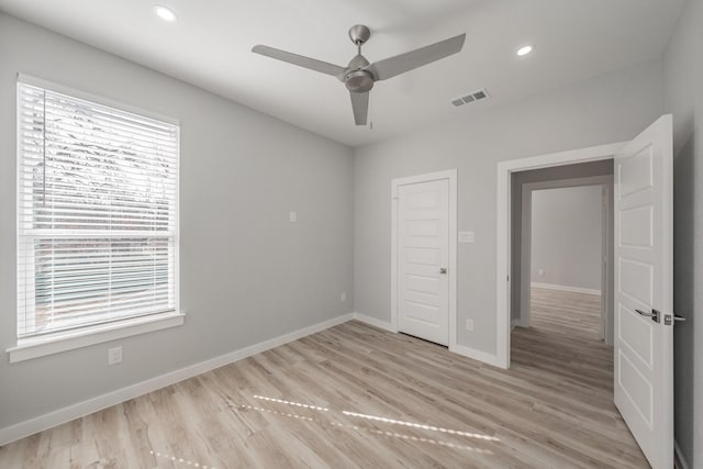 unfurnished bedroom with ceiling fan and light hardwood / wood-style floors