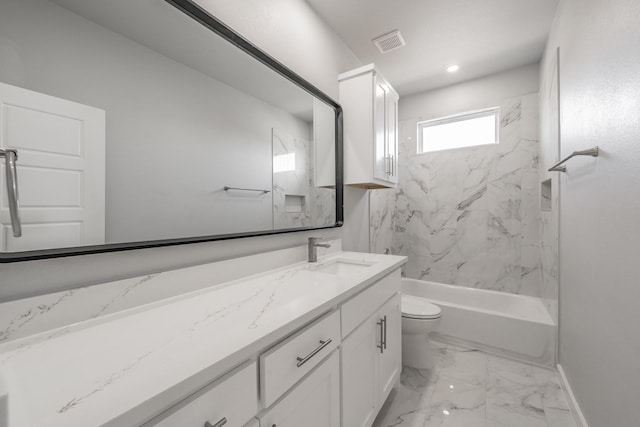 full bathroom featuring tiled shower / bath, vanity, and toilet