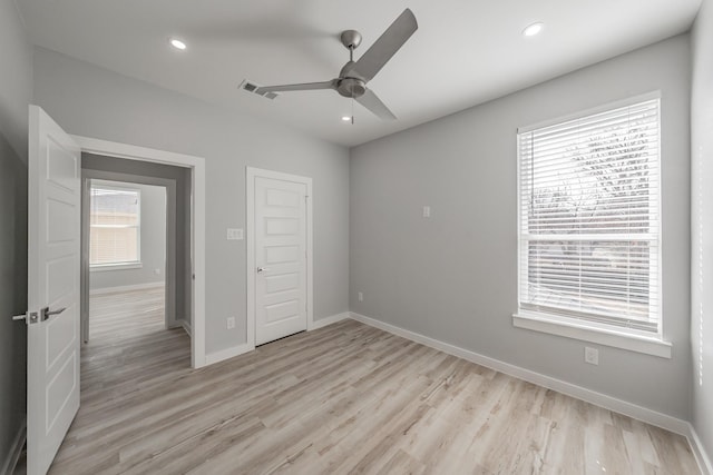 unfurnished bedroom featuring light hardwood / wood-style floors, a closet, and ceiling fan