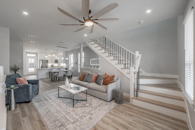 living room featuring ceiling fan and light wood-type flooring