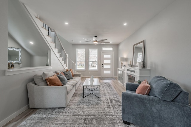 living room with hardwood / wood-style floors and ceiling fan