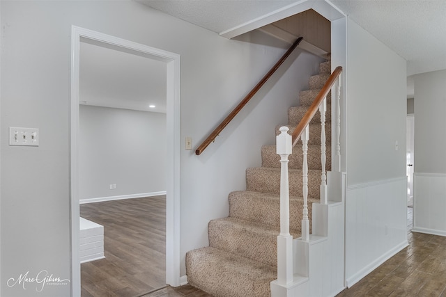 stairs with hardwood / wood-style flooring