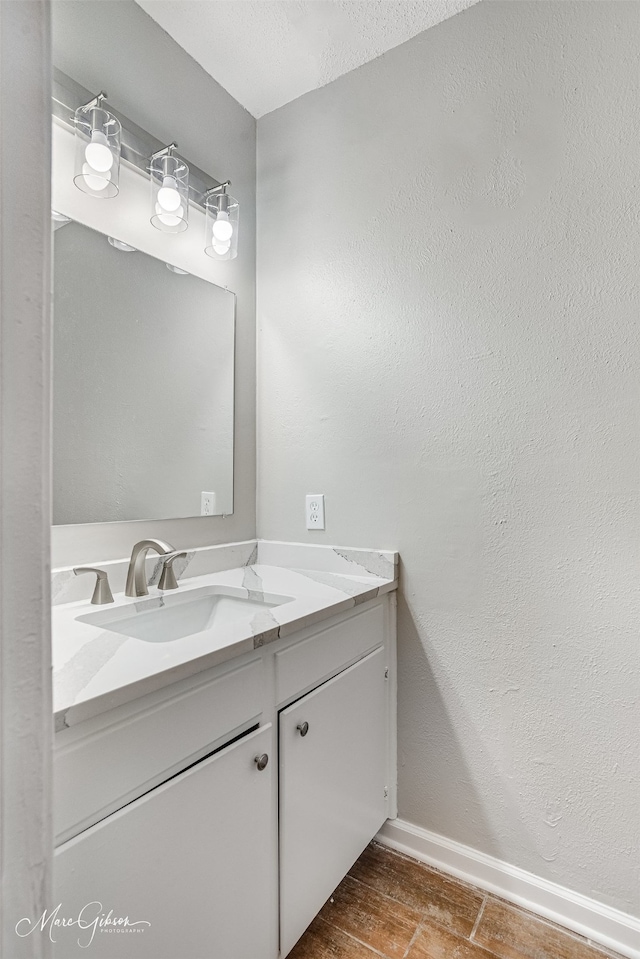 bathroom with vanity and hardwood / wood-style floors