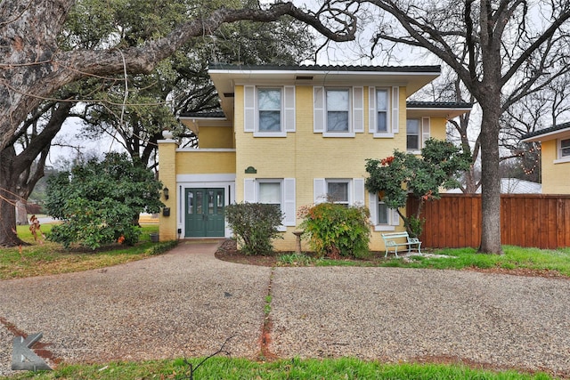 view of front of house with fence and brick siding