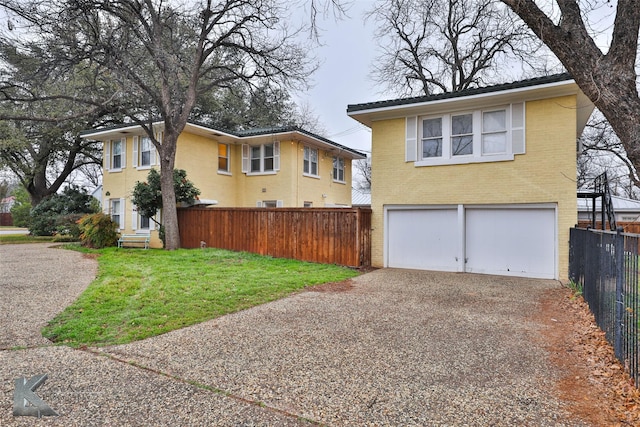 view of front of home with a garage and a front yard