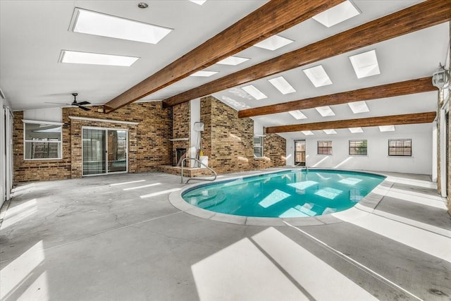 view of pool with a skylight and a jacuzzi