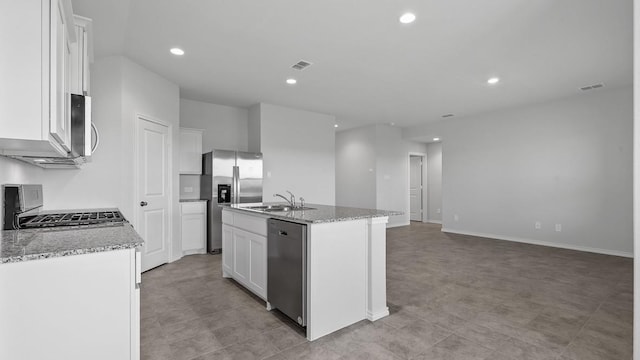 kitchen with stainless steel appliances, sink, a center island with sink, and white cabinets