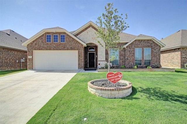 view of front of property with a garage and a front yard