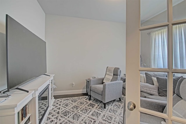 sitting room with lofted ceiling and hardwood / wood-style floors