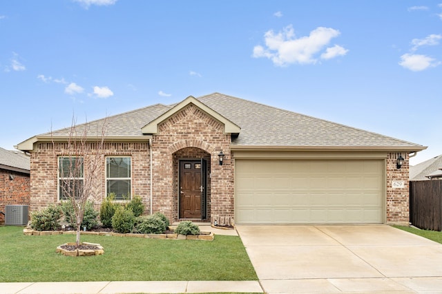 single story home with central AC unit, a garage, and a front yard