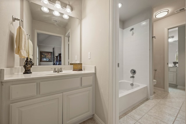 full bathroom featuring tile patterned flooring, vanity, tiled shower / bath combo, and toilet