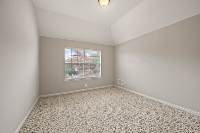 unfurnished room with lofted ceiling