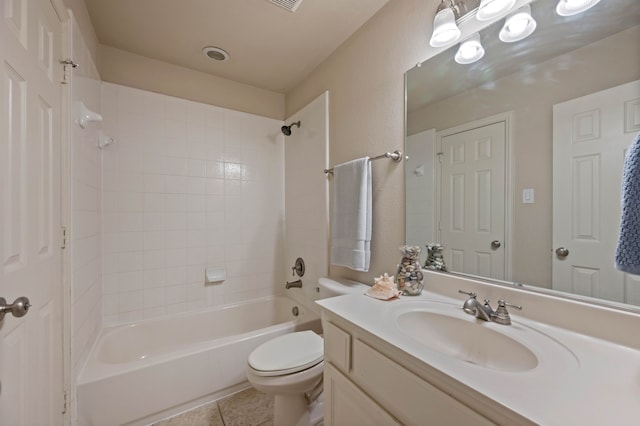 full bathroom featuring vanity, tiled shower / bath combo, tile patterned floors, and toilet