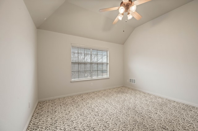 carpeted empty room with ceiling fan and vaulted ceiling