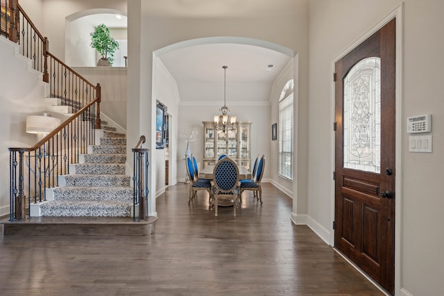 entrance foyer featuring dark wood-type flooring and a notable chandelier