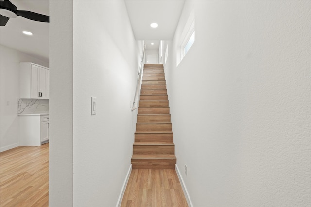 stairs featuring recessed lighting, ceiling fan, baseboards, and wood finished floors