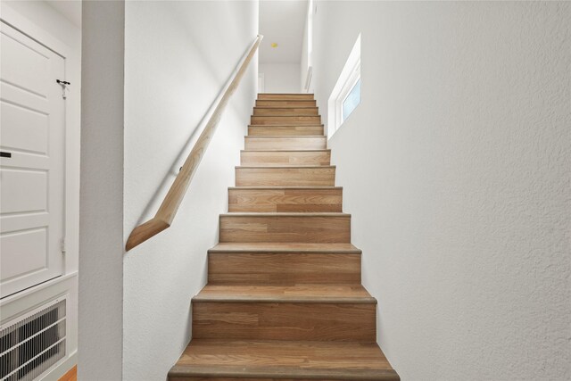 corridor featuring baseboards and light wood-style floors