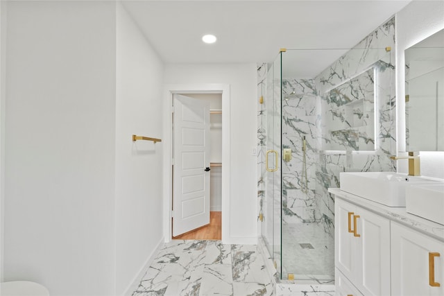 bathroom with a marble finish shower, baseboards, marble finish floor, vanity, and recessed lighting