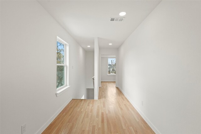 unfurnished bedroom with baseboards, light wood finished floors, visible vents, and recessed lighting