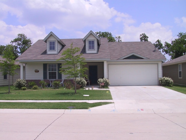 view of front facade with a garage and a front lawn