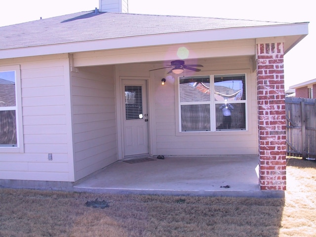 entrance to property with a patio area and ceiling fan