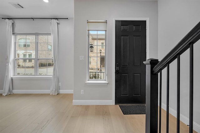 4413 Murphy Ln, Carrollton, TX 75010 - entrance foyer with light wood-type flooring, baseboards, visible vents, and plenty of natural light