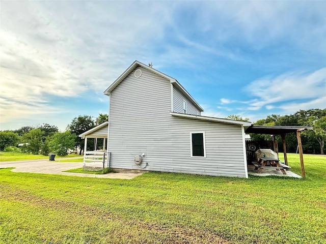 view of property exterior with a carport and a lawn