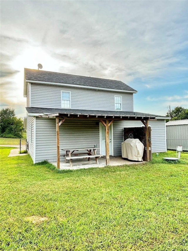 back of house featuring a patio and a lawn