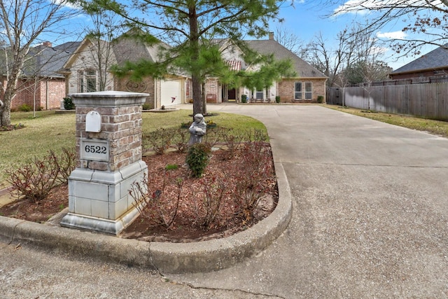 view of front facade with a garage and a front lawn